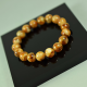 The bracelet is made of polished amber balls marble colored amber beads
