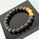 The bracelet is made of unpolished amber balls and polished marble colored amber beads