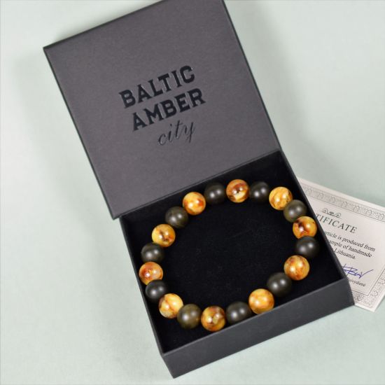 The bracelet is made of unpolished amber balls and polished marble colored amber beads