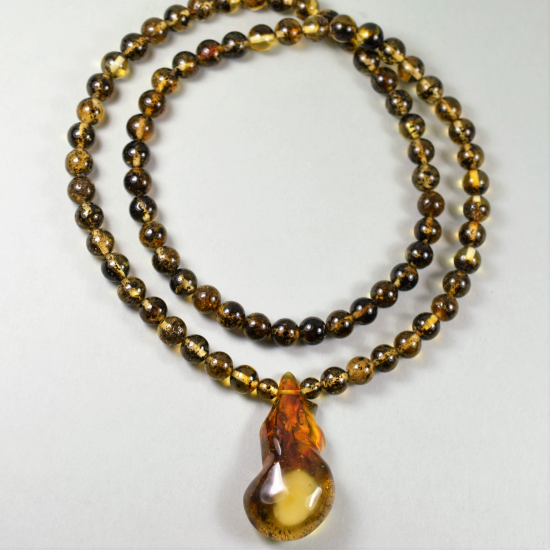 Round amber necklace with pendant from a piece of natural amber formed by nature