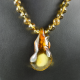 Round amber necklace with pendant from a piece of natural amber formed by nature
