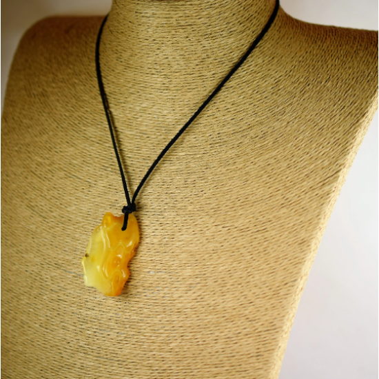 Amber pendant is engraved with leather strap